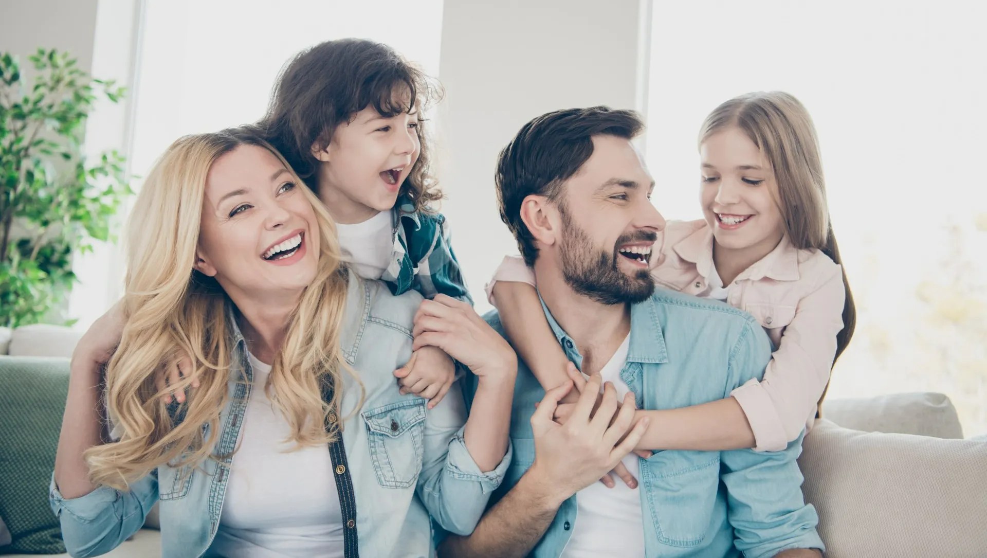 A young family laughing together at home